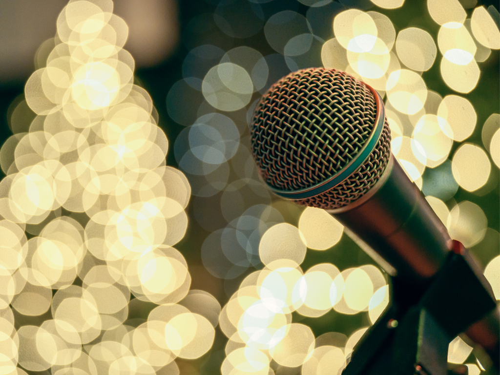 A microphone against a backdrop of sparkly white lights