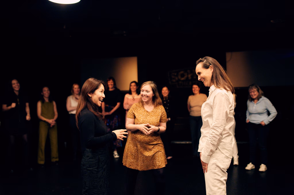 Two participants practising communication and active listening during an applied improvisation leadership workshop. AndAlso improv facilitator and director, Heather Urquhart.